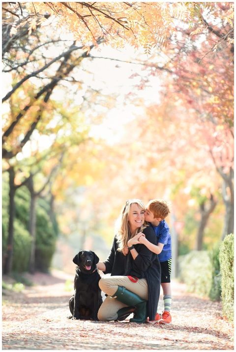 An El Dorado Hills photographer posing with her son and Black Lab dog.