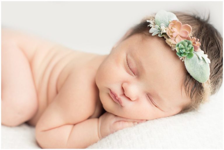 A close up of a sleeping newborn girl.