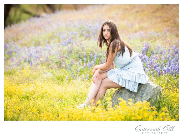 A Rolling Hills middle school graduaste poses for graduation pictures at Folsom Lake amongst Lupine wild flowers.